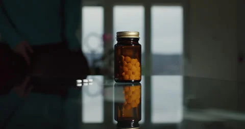 Jar Of Pills On The Glass Table Stock Footage 241239207