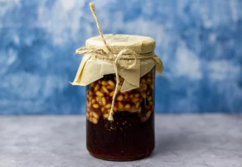 A jar of pine cone jam with pine nuts. Stock Photos