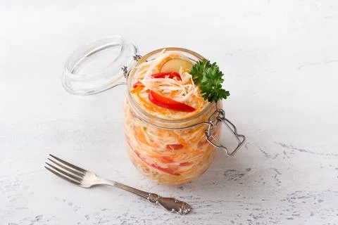 A jar of quick pickled cabbage with carrots, apples and red bell peppers Stock Photos