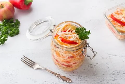 A jar of quick pickled cabbage with carrots, apples and red bell peppers Stock Photos