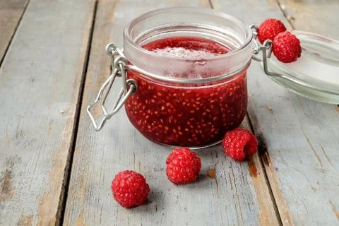 Jar of raspberry jam on the wooden table Stock Photos