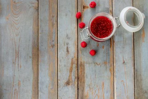 Jar of raspberry jam on the wooden table Stock Photos