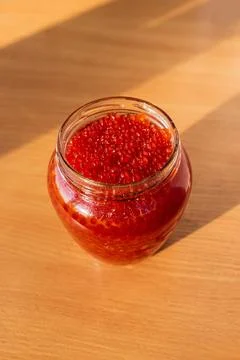 A jar of red caviar on the table Stock-Fotos