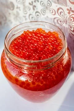 A jar of red caviar on the table Stock Photos
