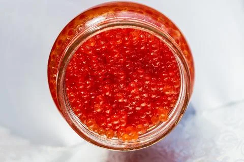 A jar of red caviar on the table Stock Photos
