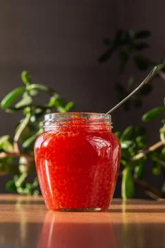 A jar of red caviar on the table Stock Photos
