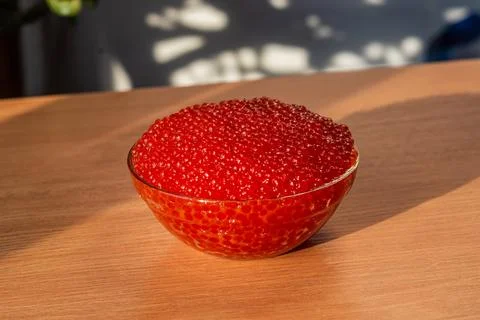 A jar of red caviar on the table Stock Photos