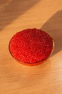 A jar of red caviar on the table Stock Photos