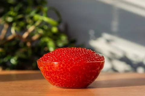 A jar of red caviar on the table Stock Photos