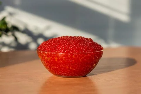 A jar of red caviar on the table Stock Photos