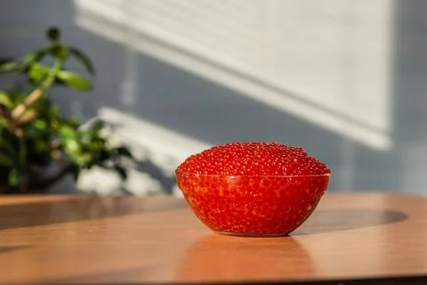 A jar of red caviar on the table Stock Photos