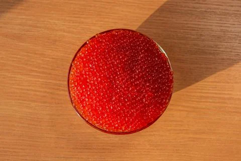 A jar of red caviar on the table Stock Photos