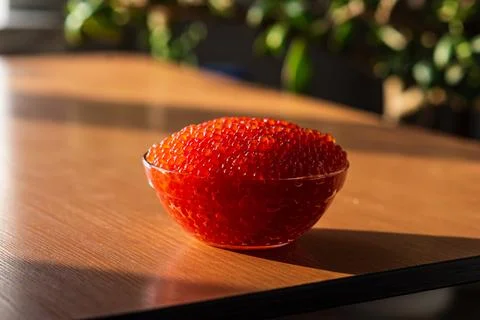 A jar of red caviar on the table Stock Photos