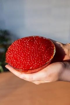 A jar of red caviar on the table Stock Photos