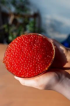 A jar of red caviar on the table Stock Photos