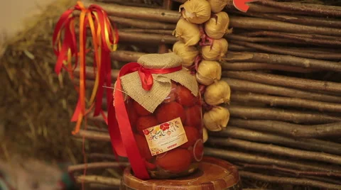 Jar with red tomatoes  on a background of  fence of twigs Video stock 45793911