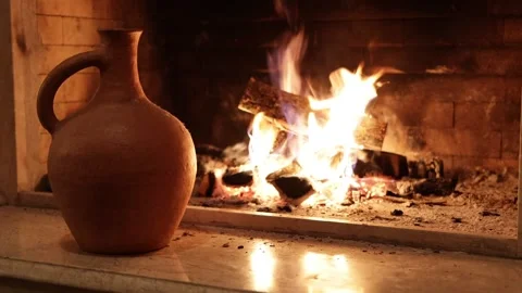 Jar sitting on a fireplace with a fire in the background and a fire in the Stock Footage 230556681