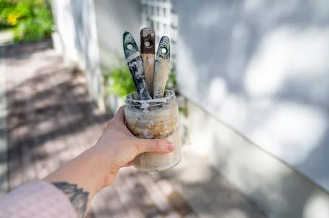 Jar with soaking paintbrushes Stock Photos