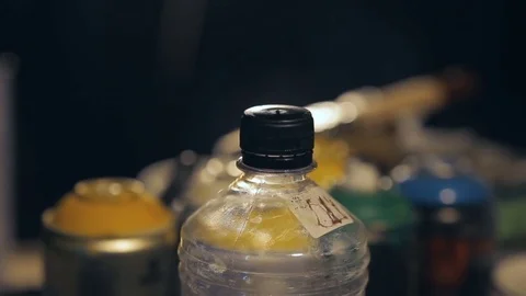 Jar With Solvent and Cans With Paint in the Artist's Studio Video stock 82383188