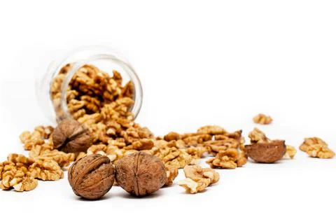 Jar of spilled walnuts with selective focus Stock Photos
