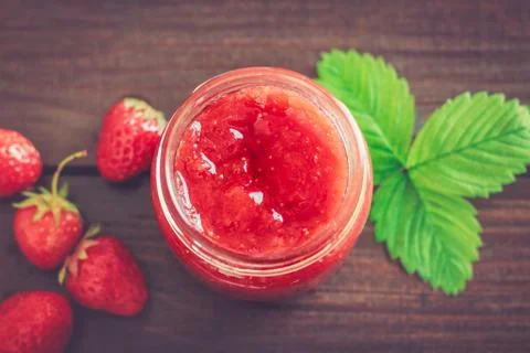 Jar of strawberry jam Stock Photos