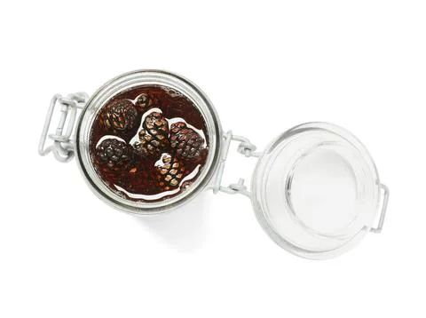 Jar of tasty pine cone jam on white background Stock Photos