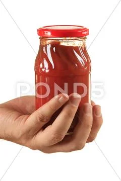 Jar tomato paste in hand Stock Photos