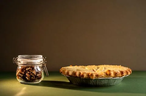 Jar of walnuts and pie. Stock Photos