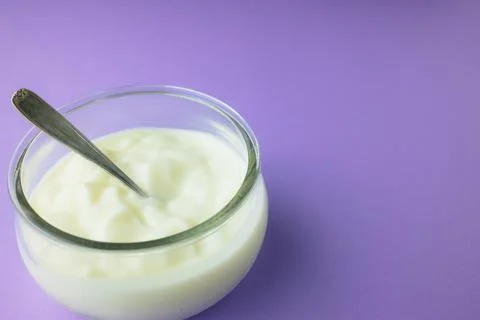 Jar of yogurt with a small spoon Stock Photos