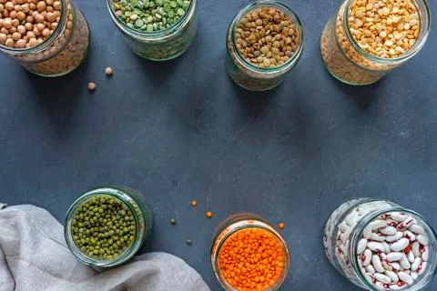 Jars of assorted dried lentils forming a border Stock Photos