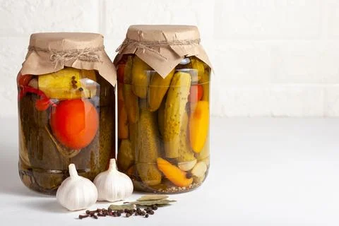 Jars of assorted pickled vegetables with garlic and spices 스톡 사진