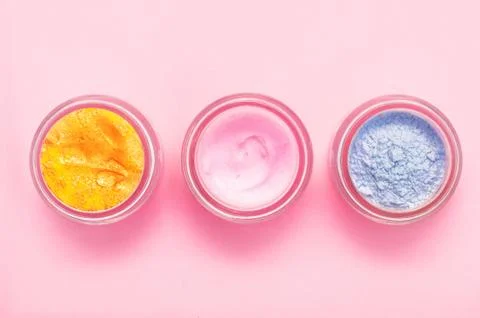 Jars of body cream on color background Stock Photos