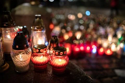 Jars with burning candles on stone surface at night Stock Photos