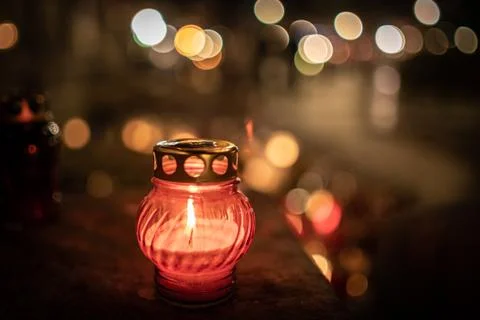Jars with burning candles on stone surface at night Stock Photos