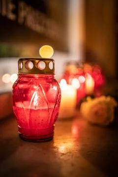 Jars with burning candles on stone surface at night Stock Photos