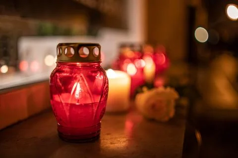 Jars with burning candles on stone surface at night Stock Photos