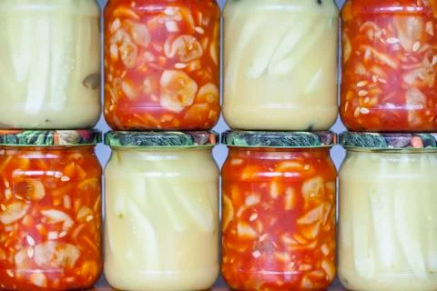 Jars with cucumber preserves inside Stock Photos