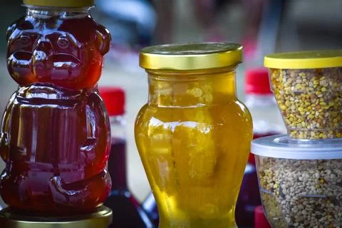 Jars with different kinds of fruit and vegetable juices in market. Stock Photos
