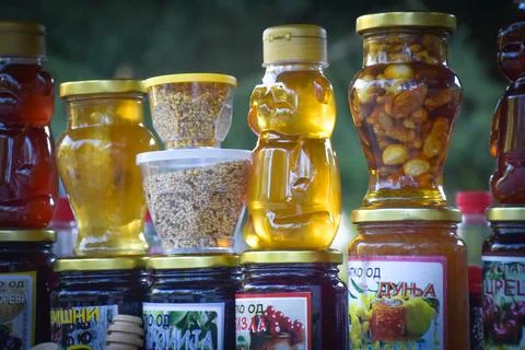Jars with different kinds of fruit and vegetable juices in market. Stock Photos