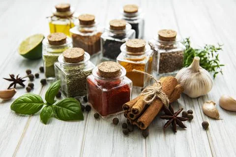Jars with dried herbs, spices on the table Stock Photos