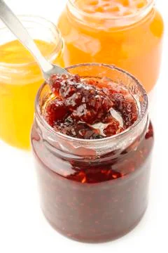 Jars of fruity jam on white background Stock Photos