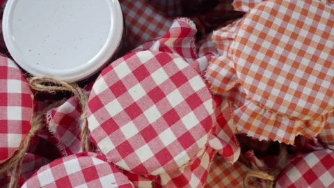 Jars of Homemade Preserves with Gingham Covers are a charming addition to a Stock Footage 277679034