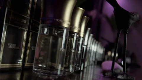 Jars of liquid stand in a row in a purple room Stock Footage 137588487