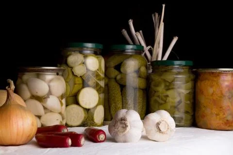Jars with pickled vegetables on dark background Stock Photos