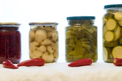 Jars with pickled vegetables on white background Stock Photos