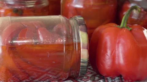 Jars of preserved bell pepper and fresh vegetables close up Stock Footage 345257530
