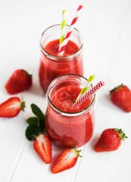 Jars with strawberry smoothie Stock Photos
