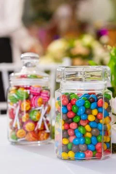 Jars with sweets of different colors. Stock Photos