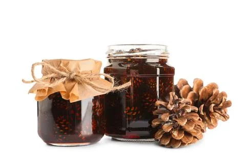 Jars of tasty pine cone jam on white background Stock Photos