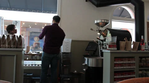 Java, Batista Packs Fresh Roasted Coffee in Coffee Shop  Stock Footage 37255580